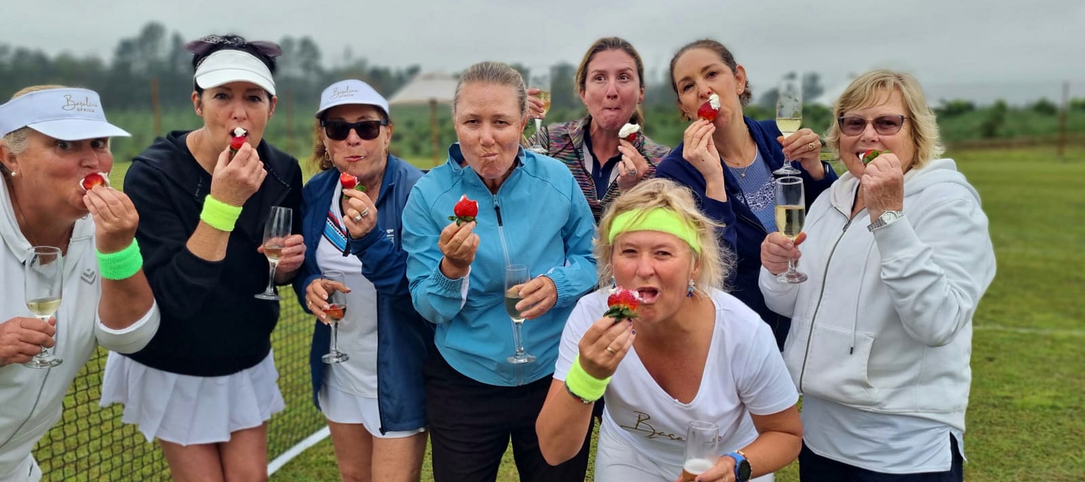 Courts of the Forest guests enjoying strawberries and cream together beside the tennis court at Portland Manor.